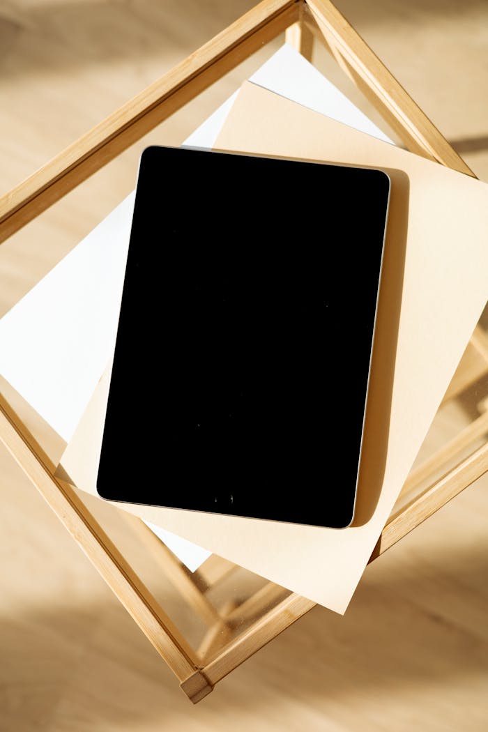 An Ipad on Top of a Blank Sheet